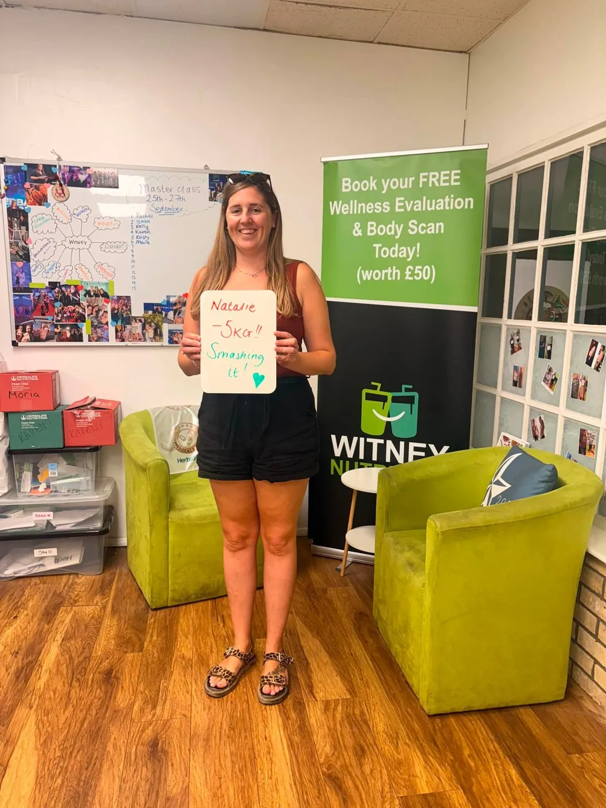 A Witney Nutrition Club member holding the board from their assessment