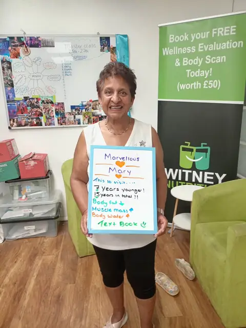 A club member holds up her assessment board at the club in Witney