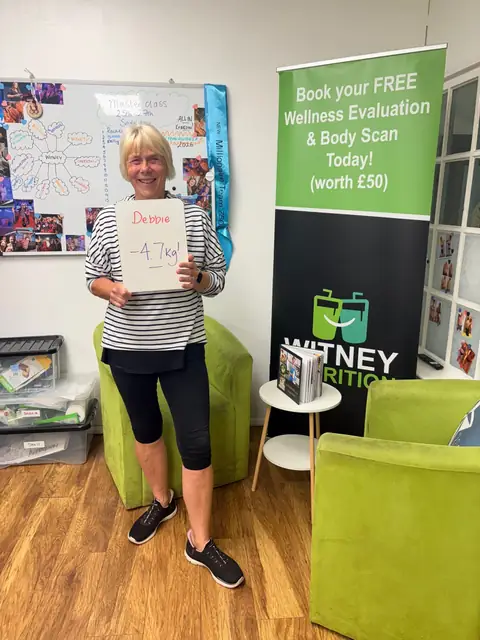 A club member holds up her assessment board at the club in Witney